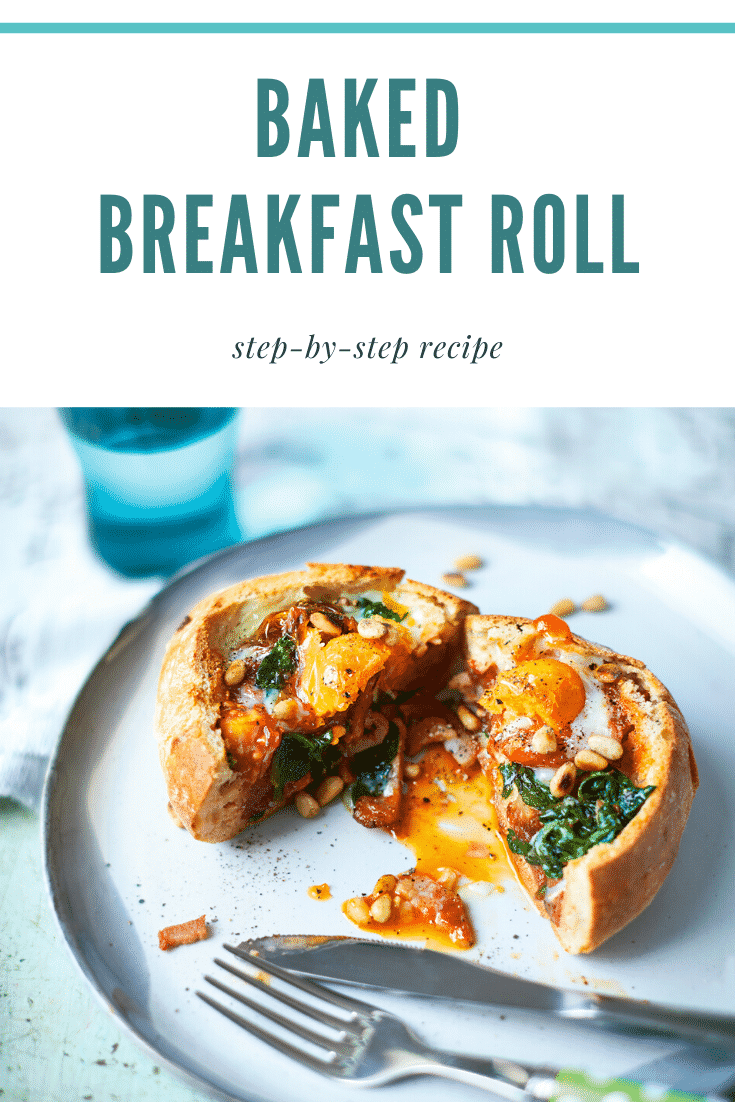 A breakfast roll on a white plate. It is filled with sausage, bacon, spinach, tomatoes and pine nuts, topped with an egg. The roll is cut open to reveal the runny egg yolk. The caption reads: baked breakfast roll step-by-step recipe