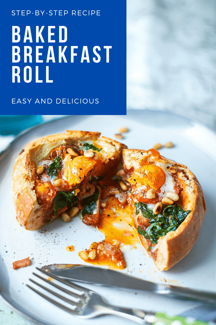 A breakfast roll on a white plate. It is filled with sausage, bacon, spinach, tomatoes and pine nuts, topped with an egg. The roll is cut open to reveal the runny egg yolk. The caption reads: step-by-step recipe baked breakfast roll easy and delicious