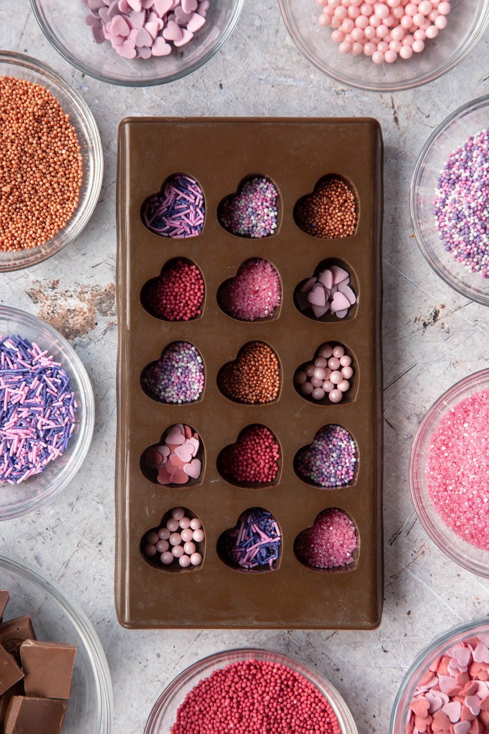 Overhead shot of brown Heart-shaped candy mould with sprinkles inside