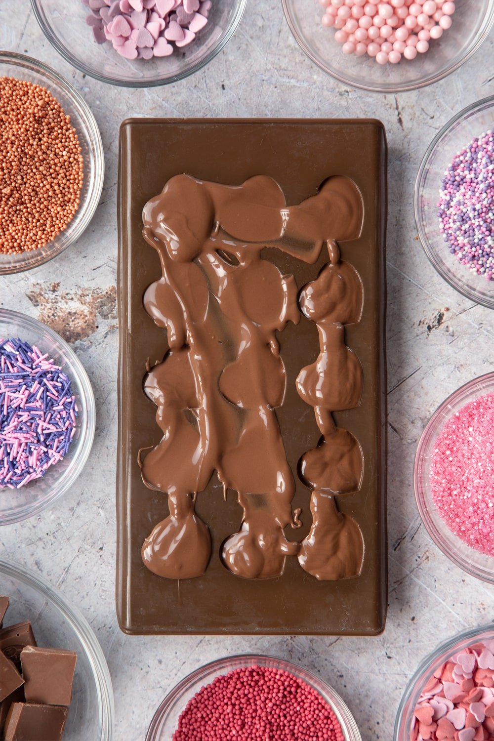 Overhead shot of melted chocolate in brown Heart-shaped candy mould