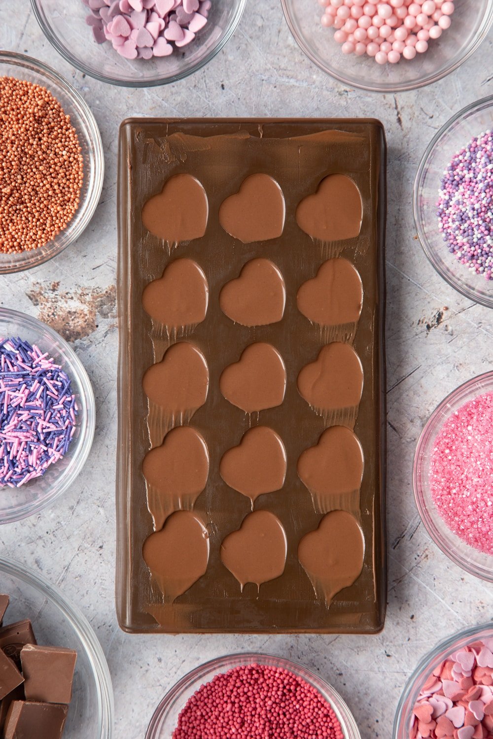 Overhead shot of scraped melted chocolate in brown Heart-shaped candy mould