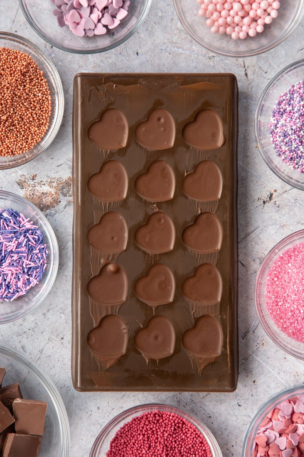 Overhead shot of chocolate in brown Heart-shaped candy mould