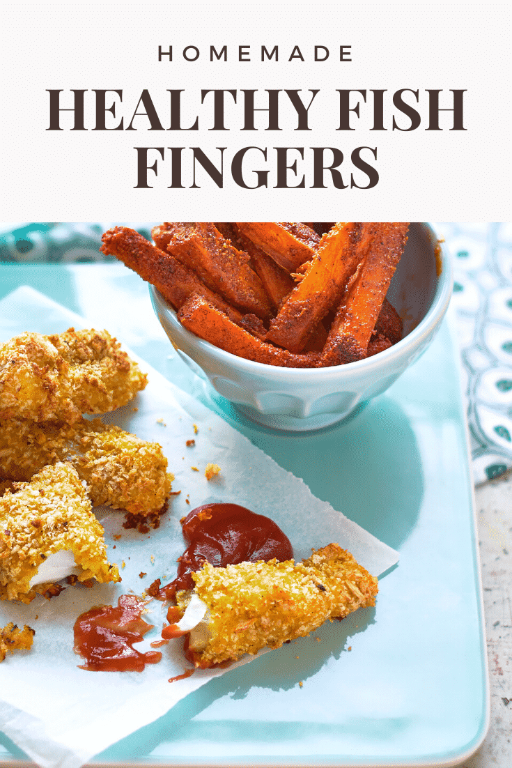 Homemade spicy fish sticks on a sheet of paper on a pale blue tray with ketchup. There are sweet potato fries in the background. The caption reads: homemade spicy fish sticks