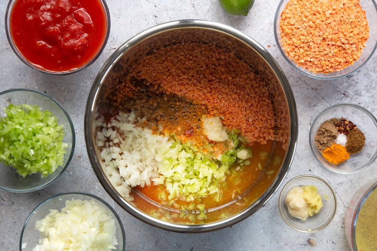 Overhead shot of lentil curry ingredients in a metal bowl