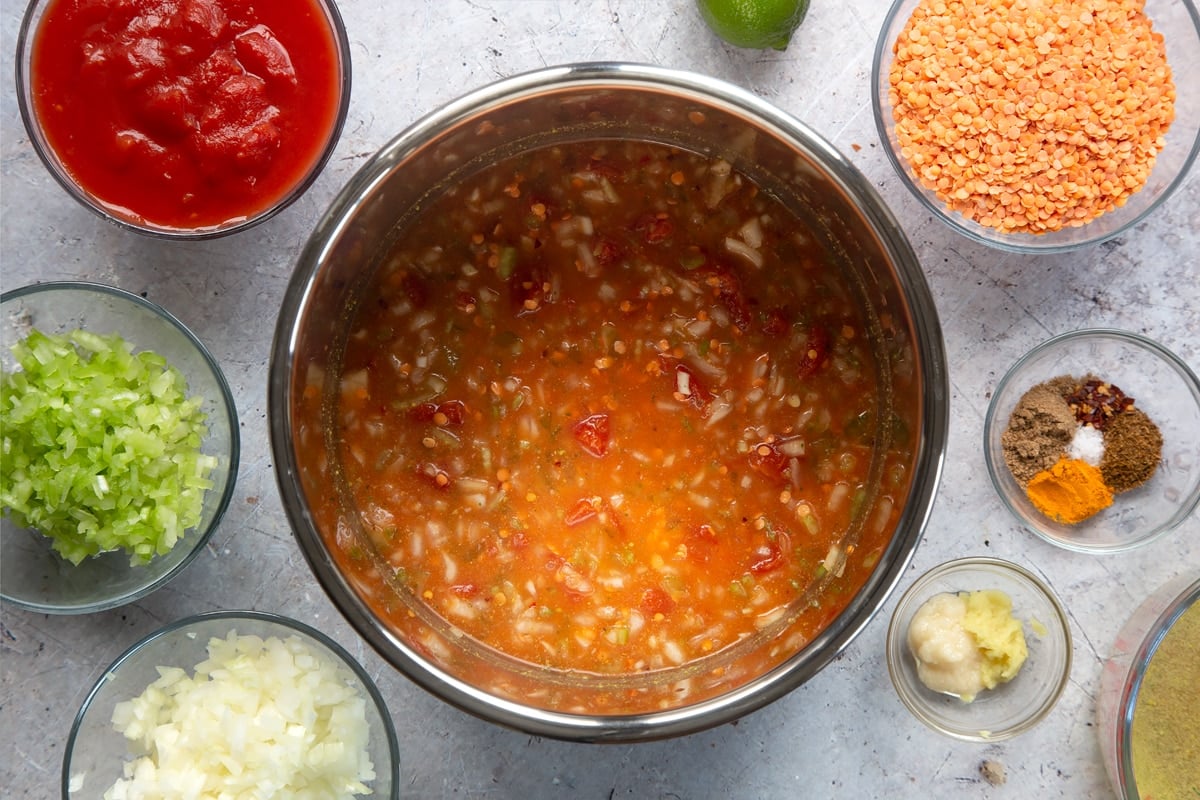 Overhead shot of mixed low fat lentil curry ingredients in a metal bowl 