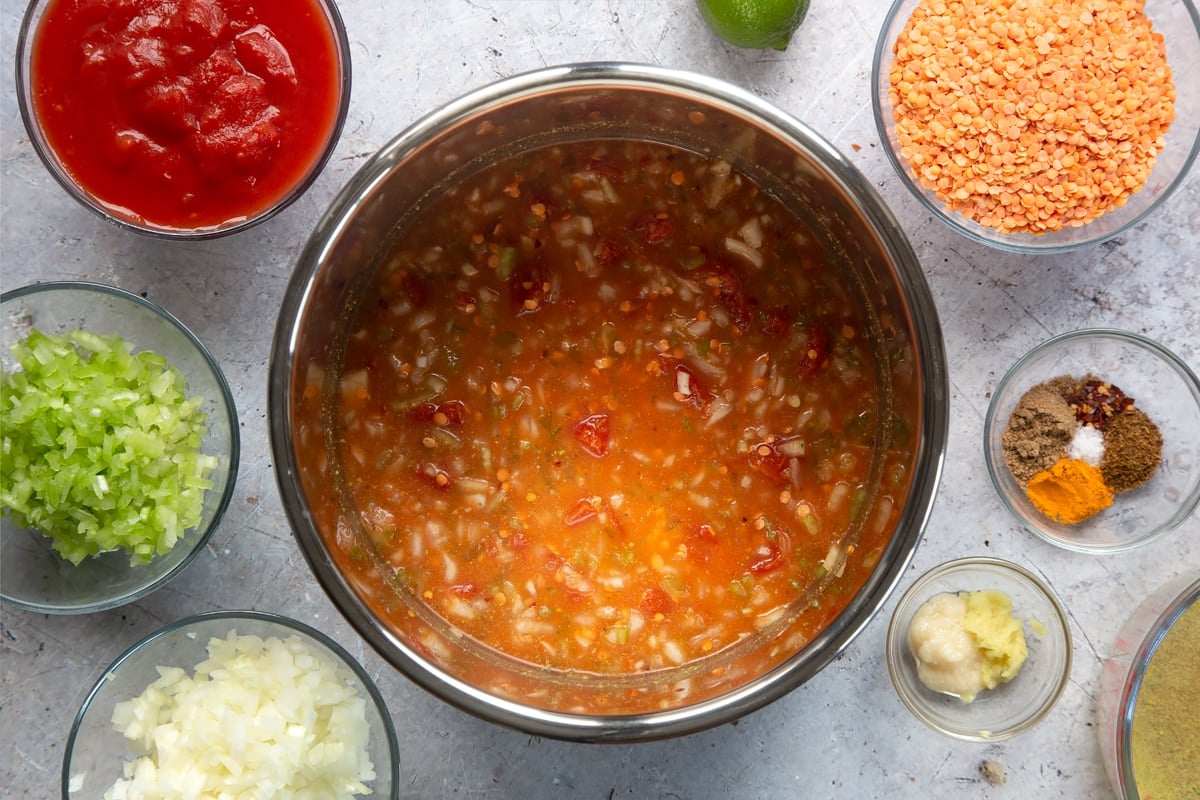 Overhead shot of mixed low fat lentil curry ingredients in a metal bowl