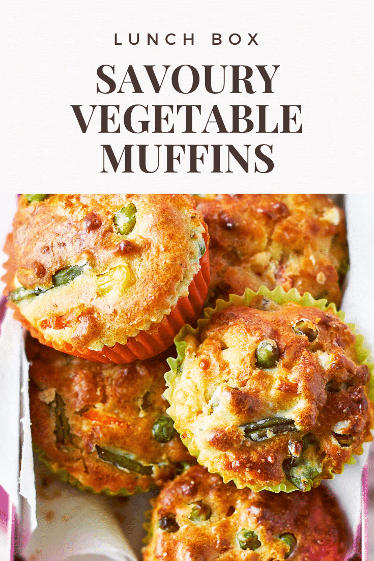 Savoury vegetable muffins in a pink lunchbox on a wooden background. The caption reads: lunch box savoury vegetable muffins