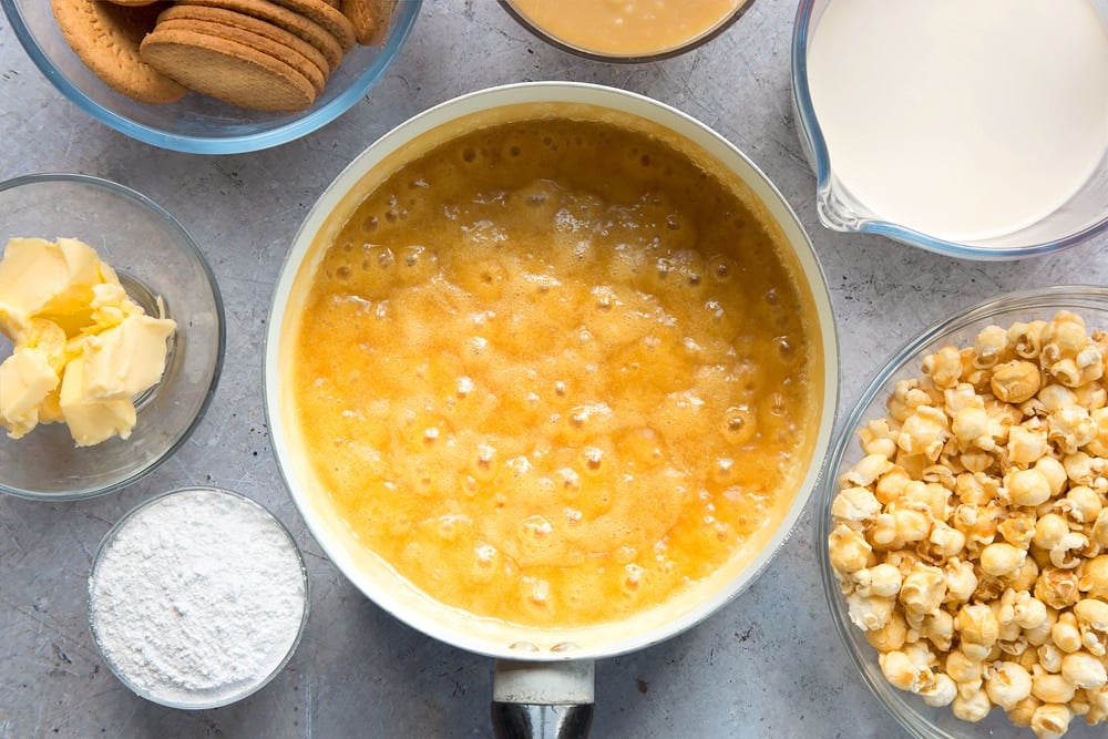 cream, butter, sugar and salt in a saucepan that has bubbled with ingredients in bowls around the pan.