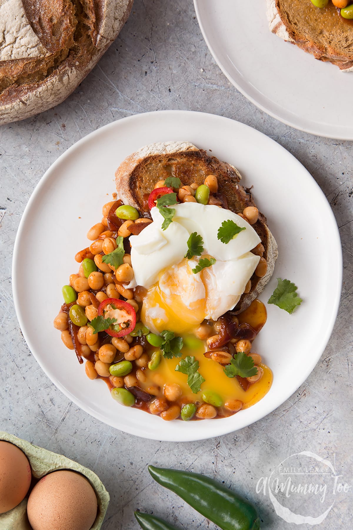 Breakfast beans with chilli, chickpeas and edamame served on sour dough toast with a poached egg on top. 