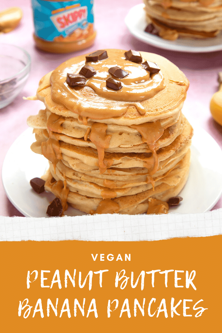 A stack of vegan peanut butter pancakes on a white plate. The stack is drizzled with more peanut butter and scattered with chunks of vegan chocolate. The caption reads: vegan peanut butter pancakes.