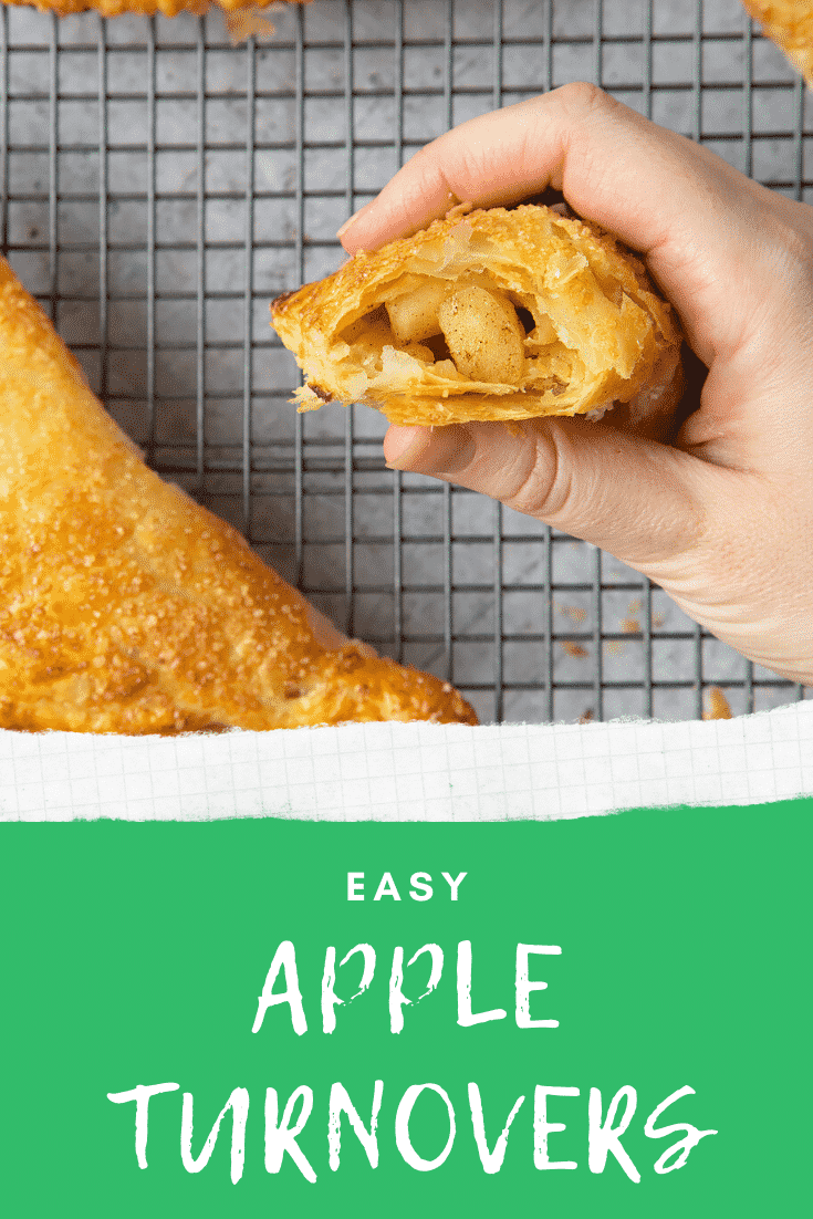 Overhead shot of inside of an apple turnover with a hand holding it. At the bottom of the image there's some text describing the image for pinterest.