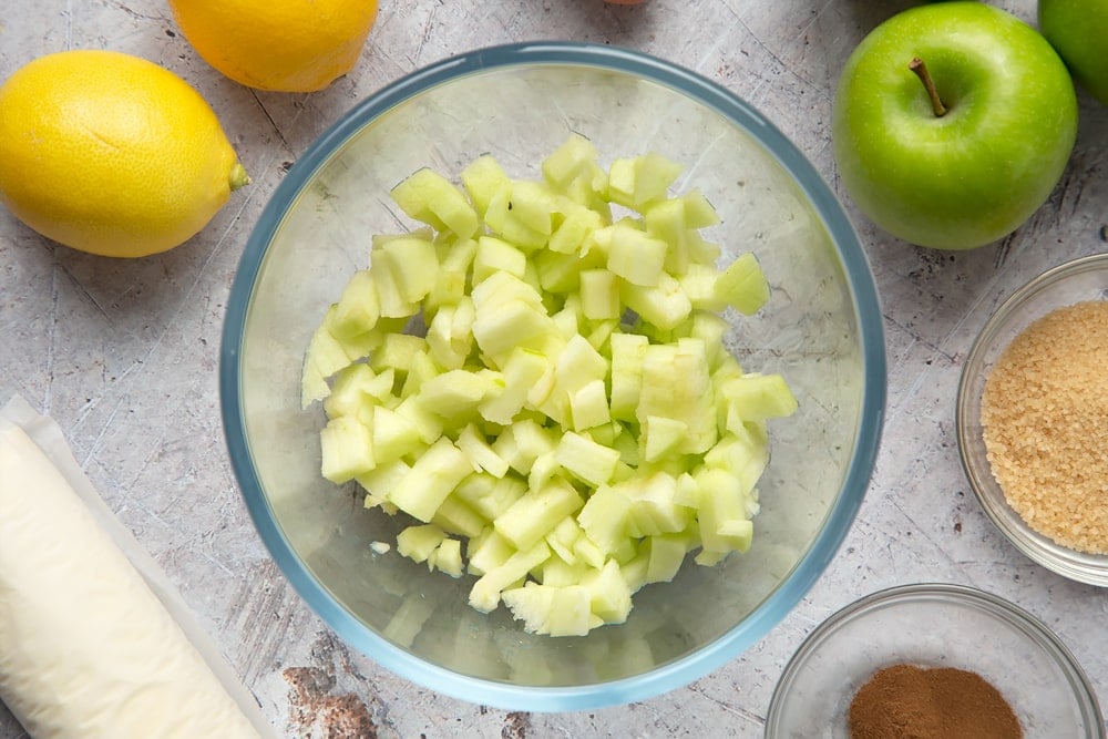 Overhead shot of chopped apples in a clear bowl