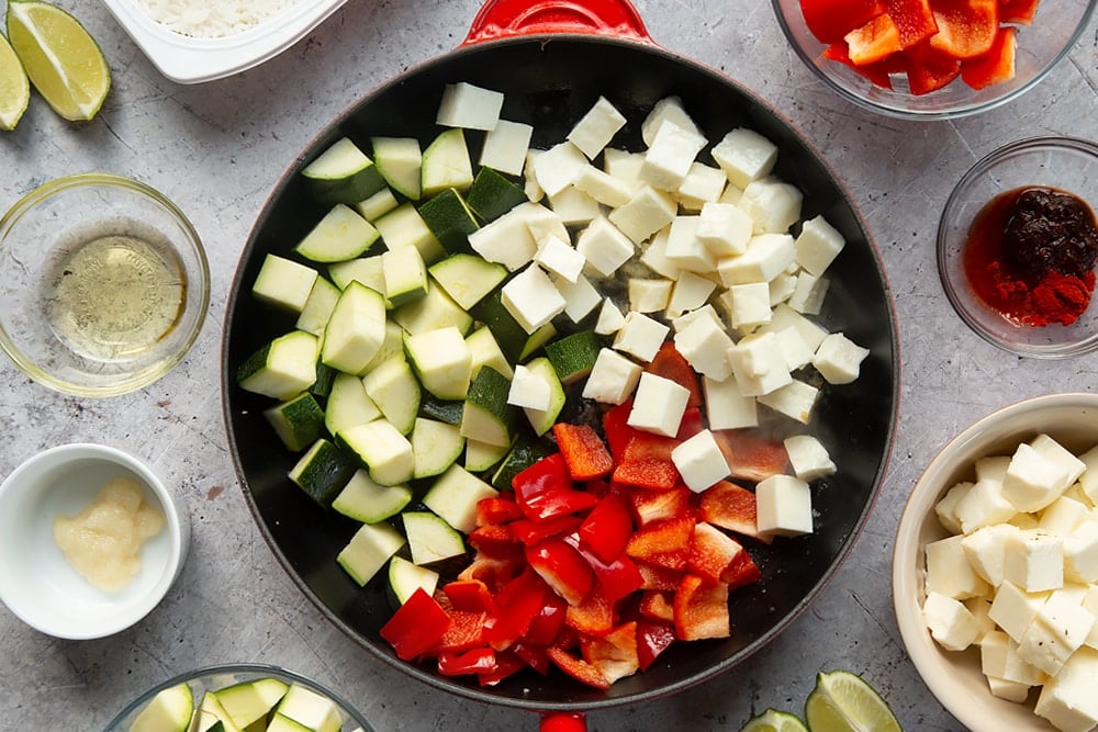 Overhead shot of oil, garlic, and fennel seeds in a large pan 