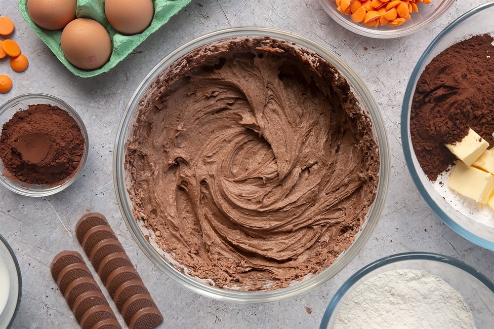 Overhead shot of chocolate orange frosting in a large mixing bowl