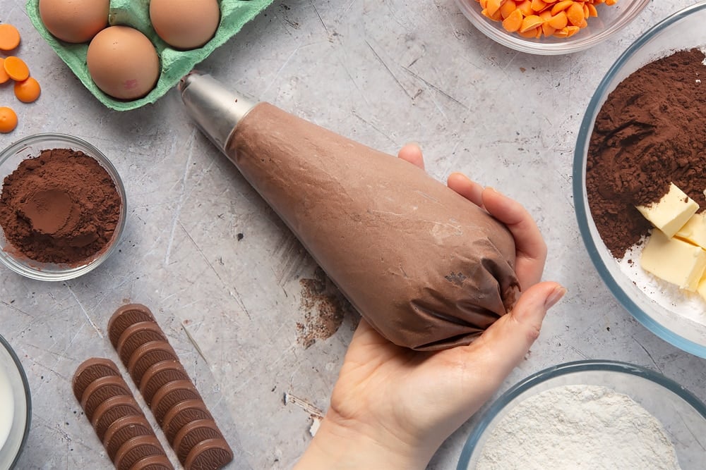 Overhead shot of chocolate orange frosting in a large mixing bowl