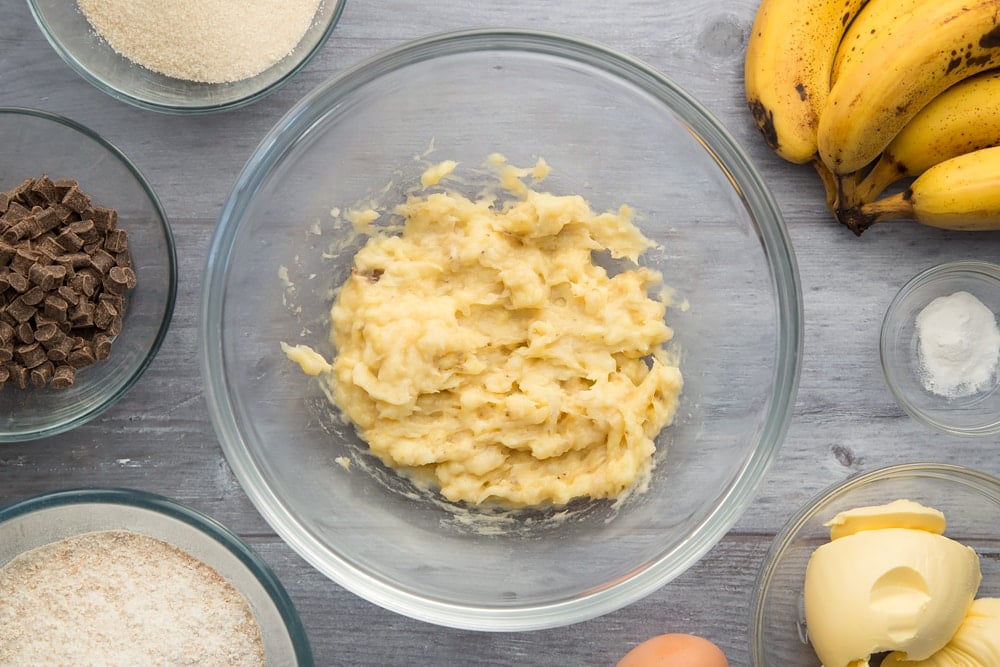 Overhead shot of Mashed banana in a large clear bowl