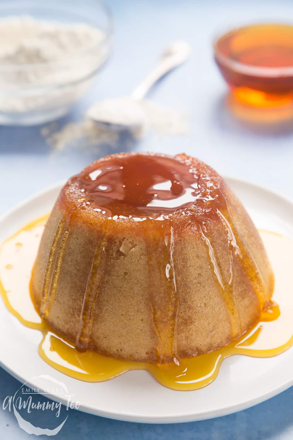 Overhead shot of pudding drizzled with syrup served in a white plate