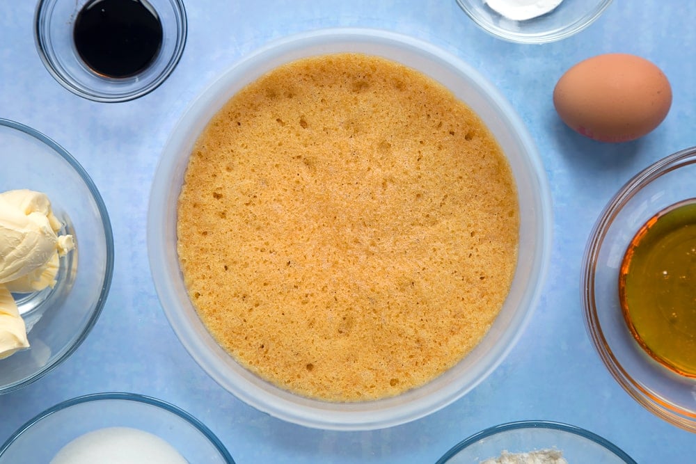 Overhead shot of cake mix covered with a lid in a large bowl