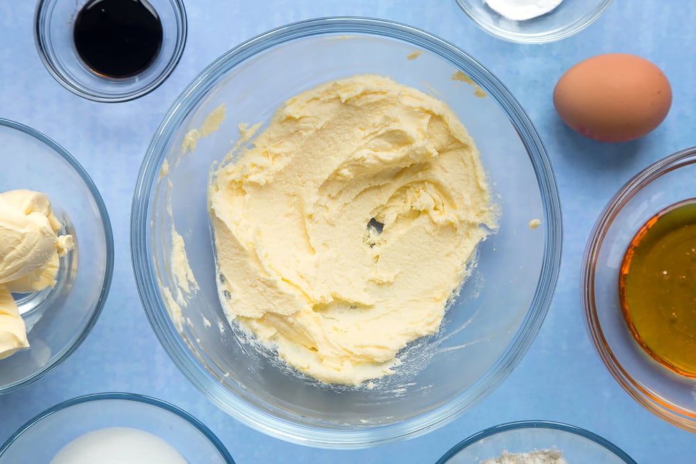 Overhead shot of mixed sugar and butter in a large clear bowl