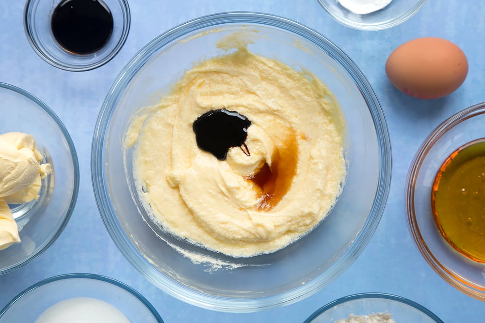 Overhead shot of butter mix with vanilla and black treacle in a large clear bowl
