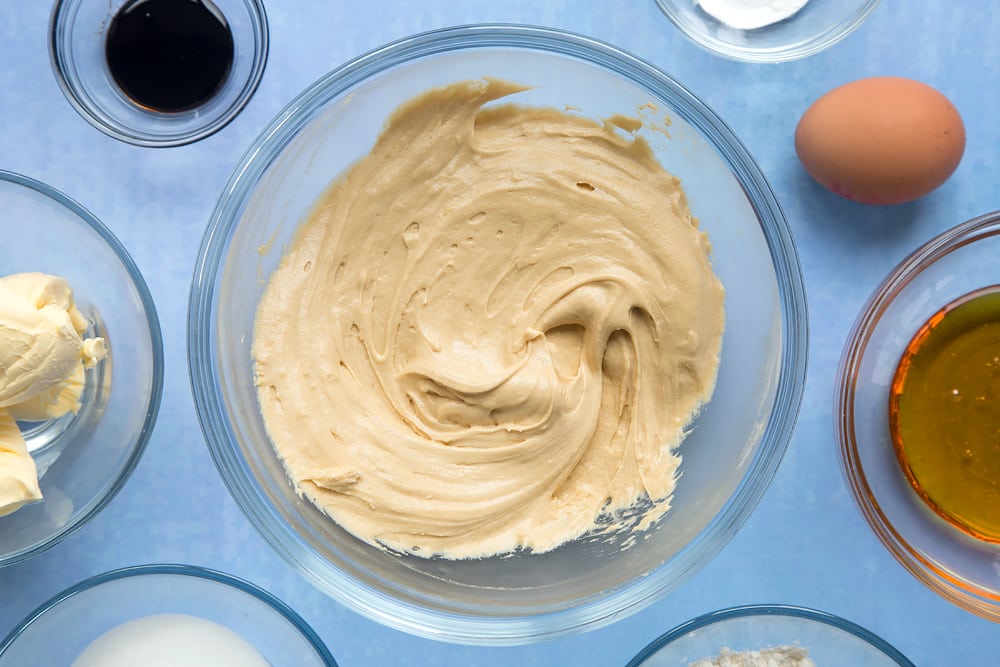 Overhead shot of butter mix, flour and baking powder in a large clear bowl