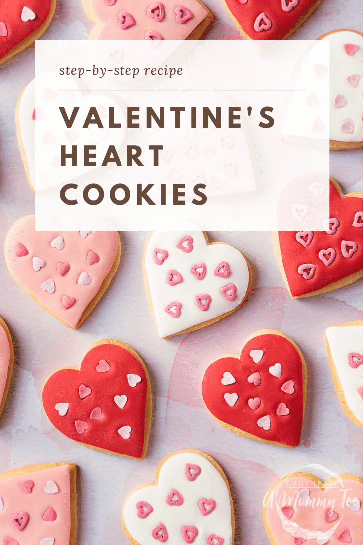 graphic text VALENTINE'S HEART BISCUITS step-by-step recipe above Overhead shot of a hand holding a heart-shaped cookies