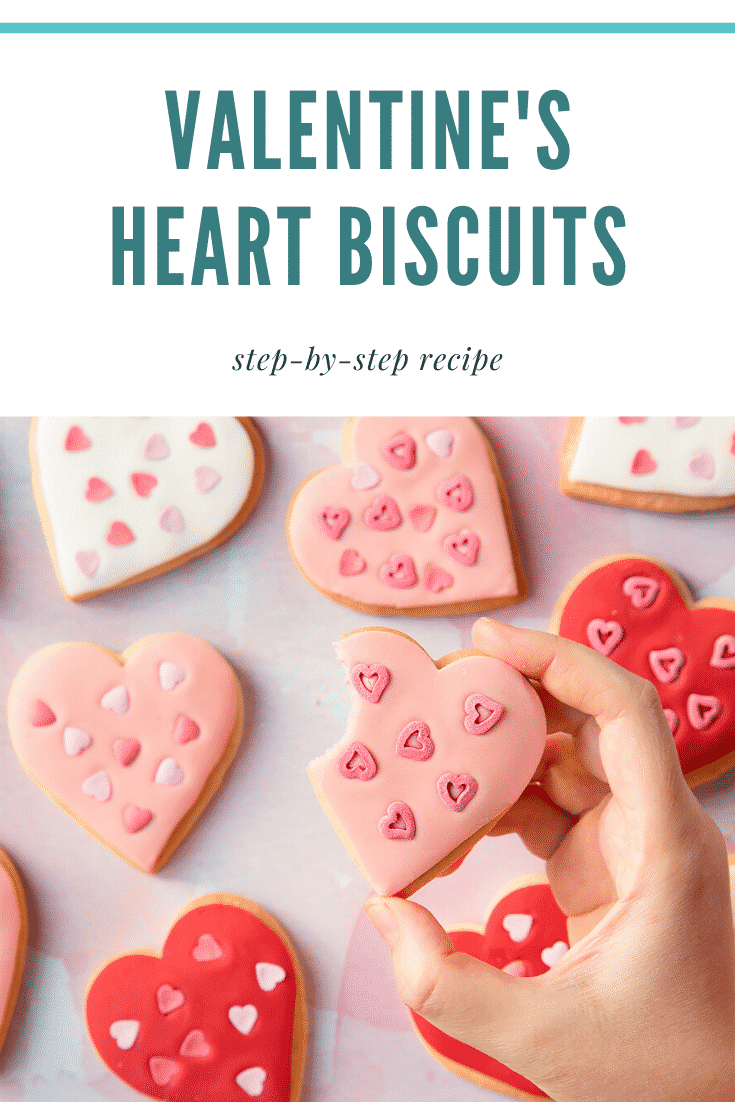 graphic text STEP-BY-STEP RECIPE VALENTINE'S HEART BISCUITS EASY AND DELICIOUS above Overhead shot of a hand touching a heart biscuit with a mummy too logo in the lower-right corner
