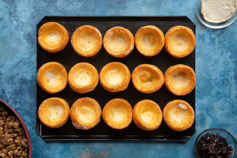 frozen mini yorkshire puddings on a lined baking tray.