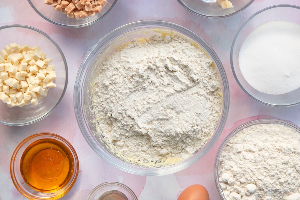 Overhead shot of flour and baking powder in a clear bowl