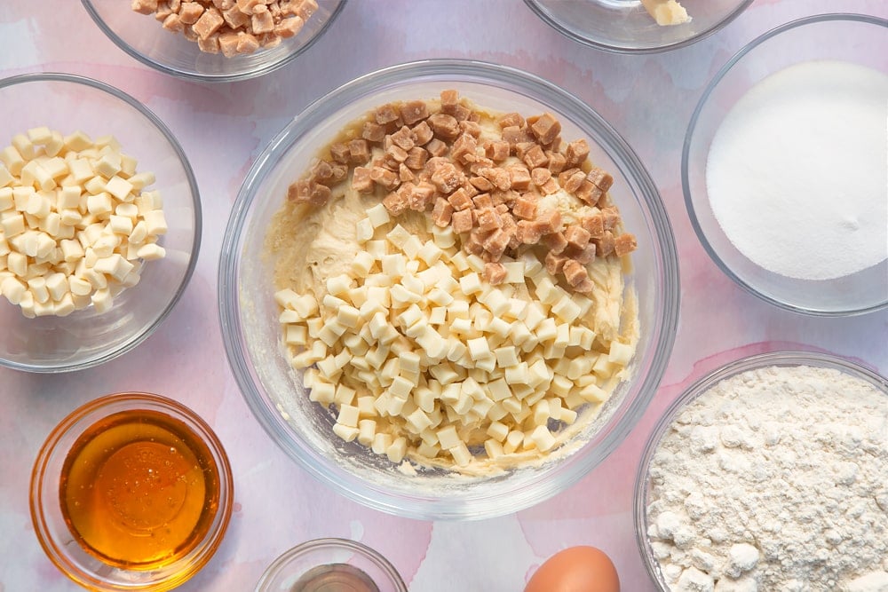 Overhead shot of white chocolate and fudge pieces in a clear bowl