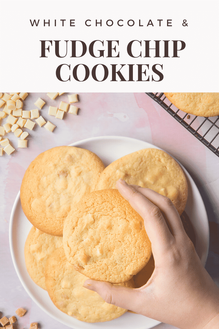 graphic text WHITE CHOCOLATE & FUDGE CHIP COOKIES aboveoverhead shot of a hand holding a white chocolate chip cookie