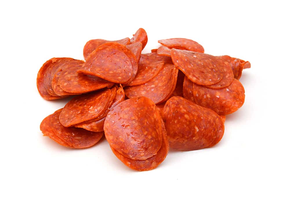 Sliced pepperoni on a white background.