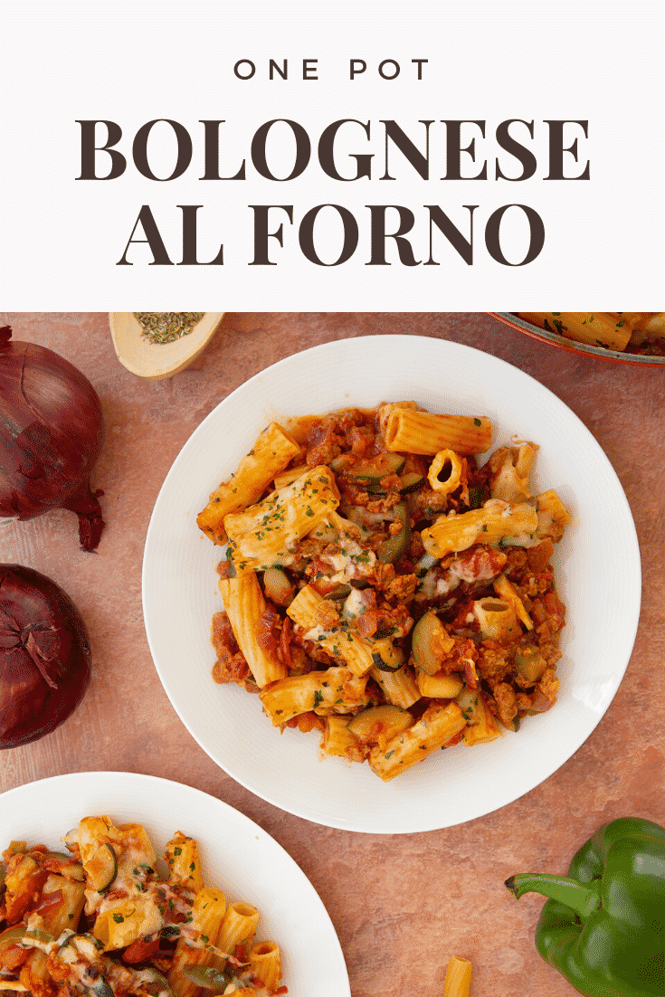 Freshly baked bolognese al forno served to two plates. Caption reads: One pot bolognese al forno