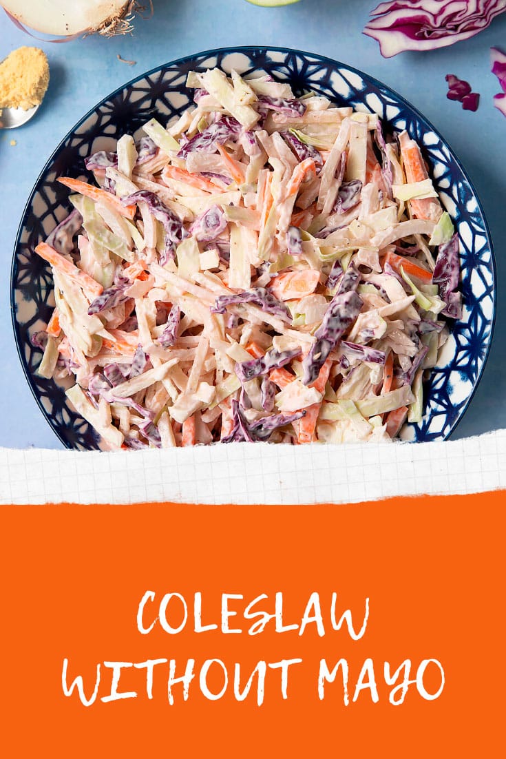 Creamy coleslaw without mayo served in a bowl. The bowl is surrounded by vegetables and creme fraiche. Caption reads: coleslaw without mayo