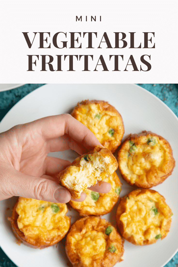 A hand holds a mini vegetable frittata about more arranged on a white plate. Caption reads: Mini vegetable frittatas.