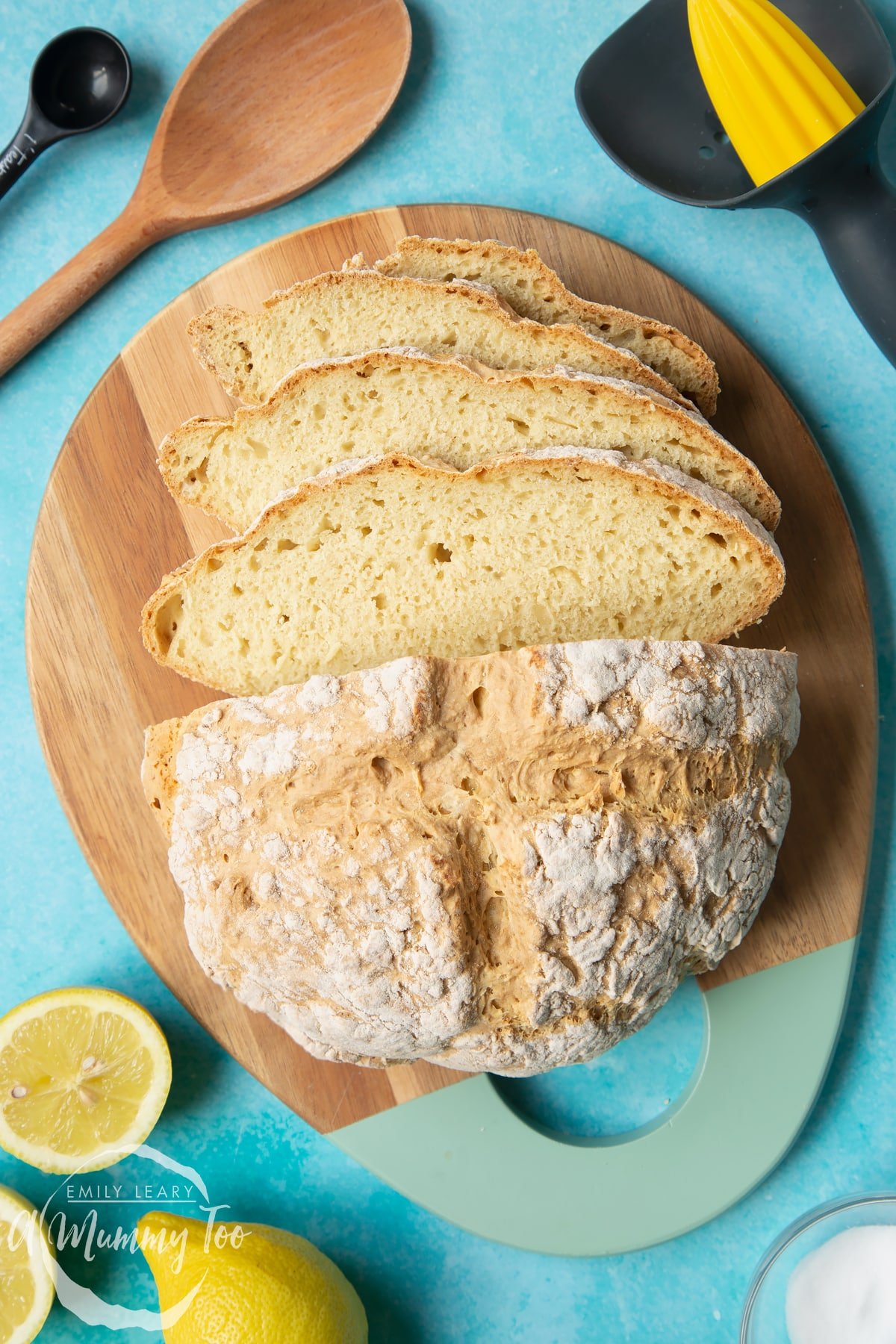 Vegan soda bread on a wooden board. Some of the bread has been cut into slices.