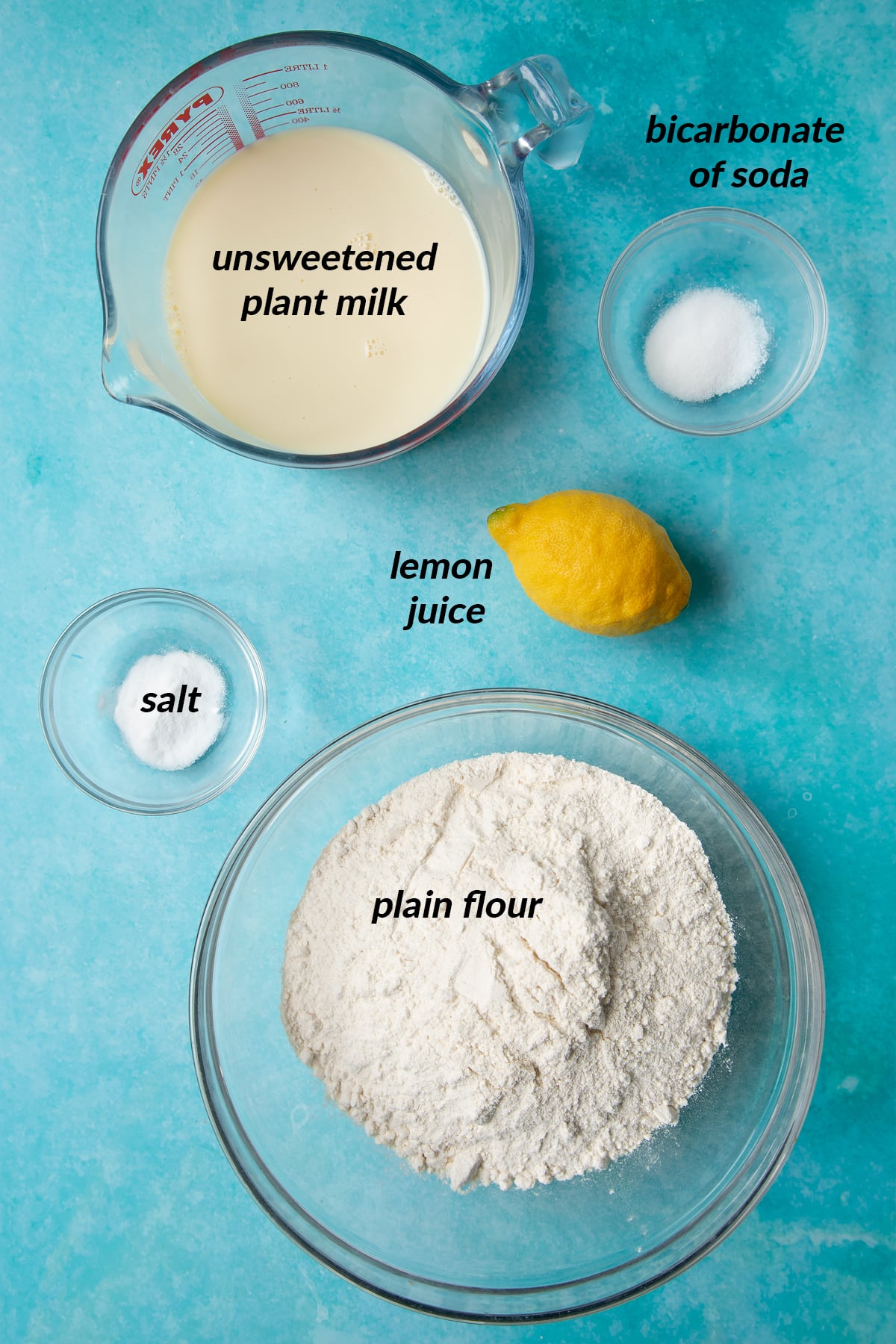 The ingredients to make vegan soda bread: plant milk, bicarbonate of soda, lemon juice, salt and plain flour.