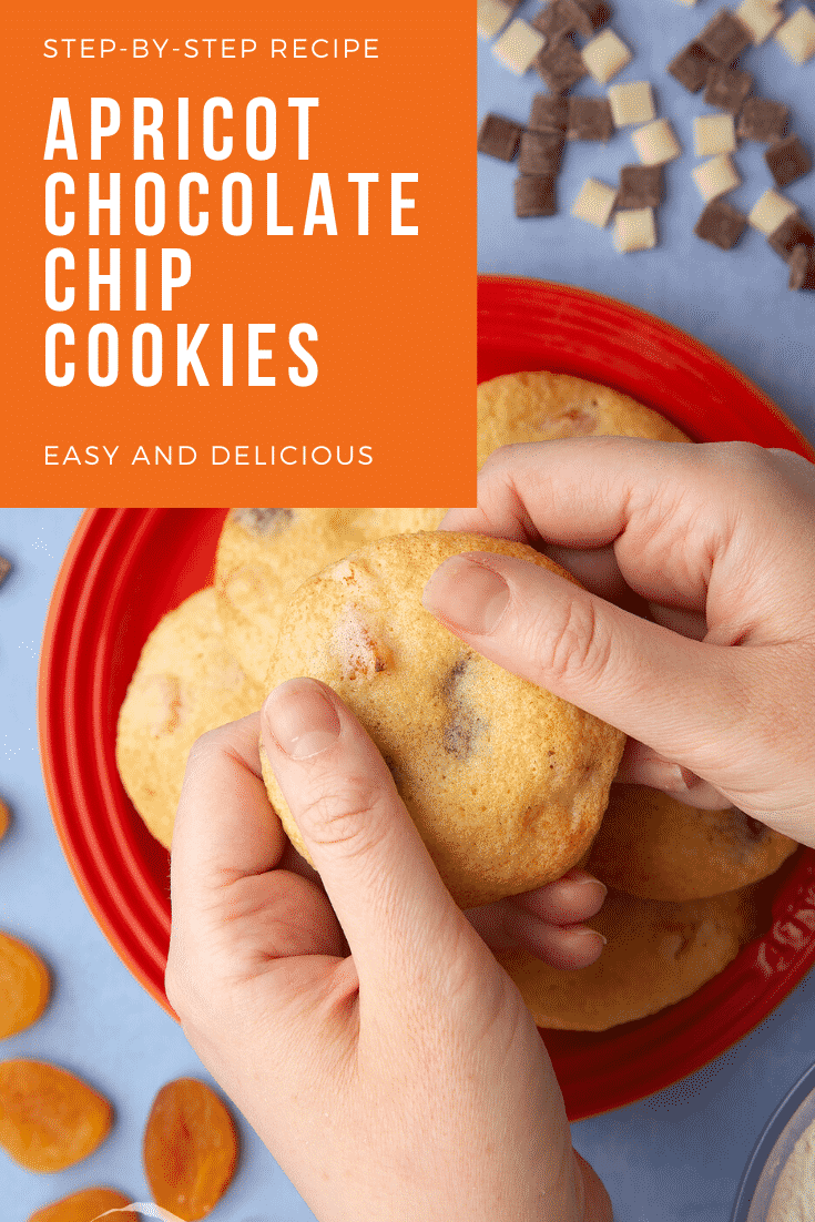 Apricot chocolate chip cookies stacked on a small orange plate. Chocolate chips and dried apricots are scattered around. Hands hold a cookie. Caption reads: step-by-step recipe apricot chocolate chips cookies easy and delicious