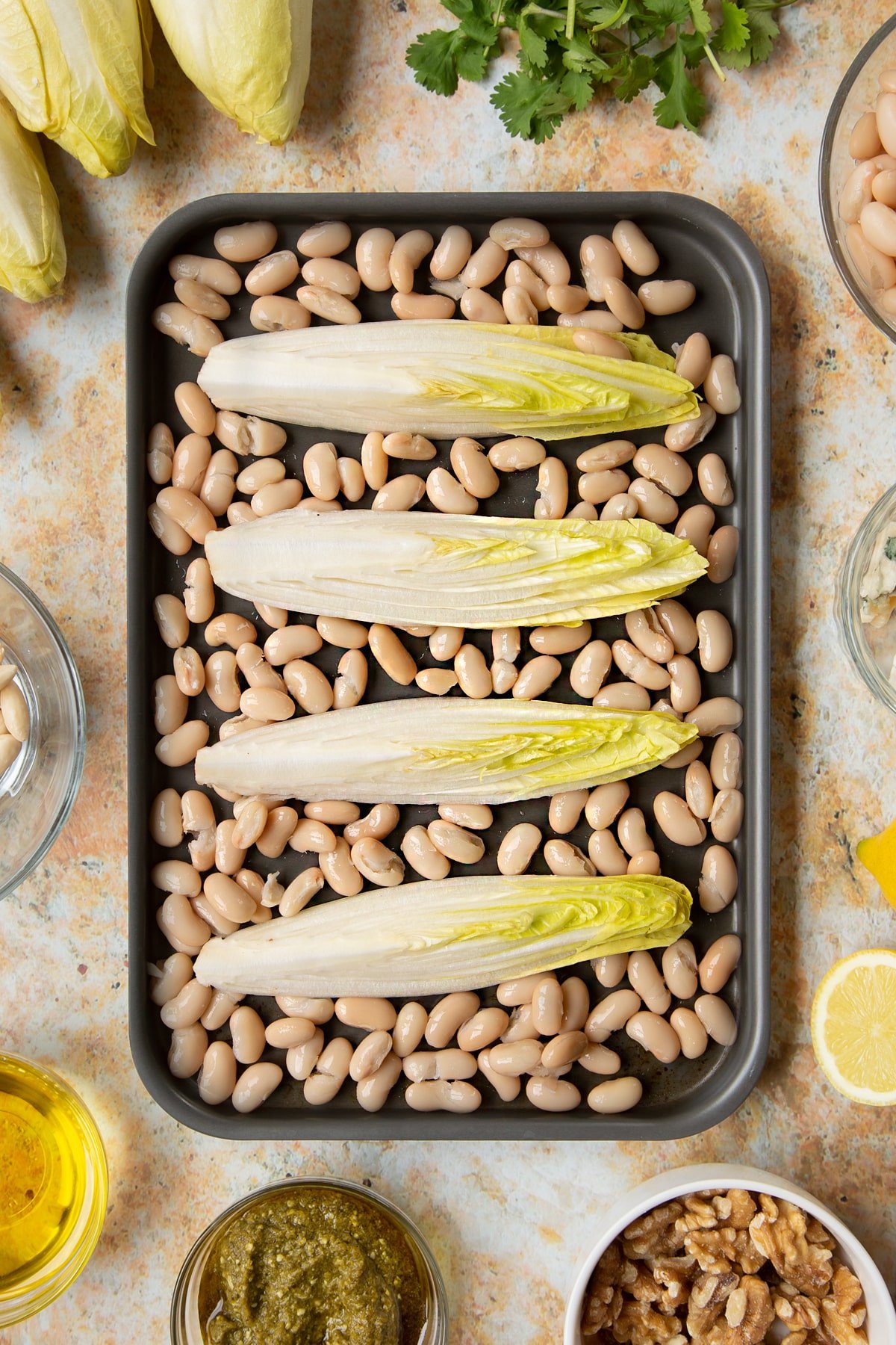 Chicory and cannellini beans on a tray.