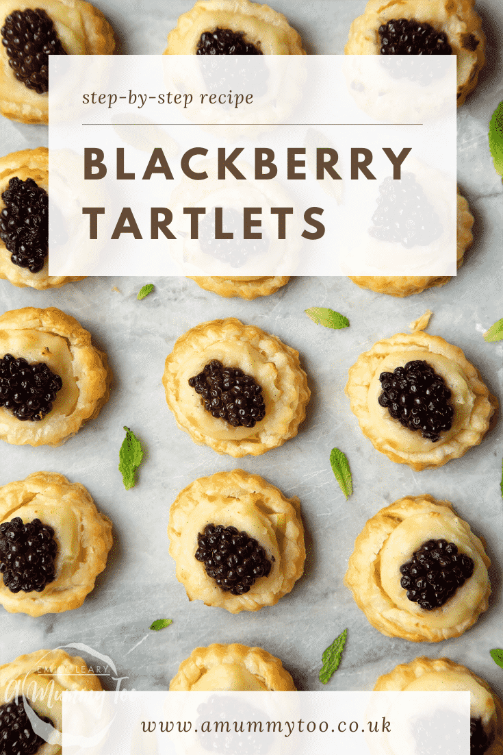 Blackberry tartlets on a marble board with tiny mint leaves scattered around them. Caption reads: step-by-step recipe blackberry tartlets.