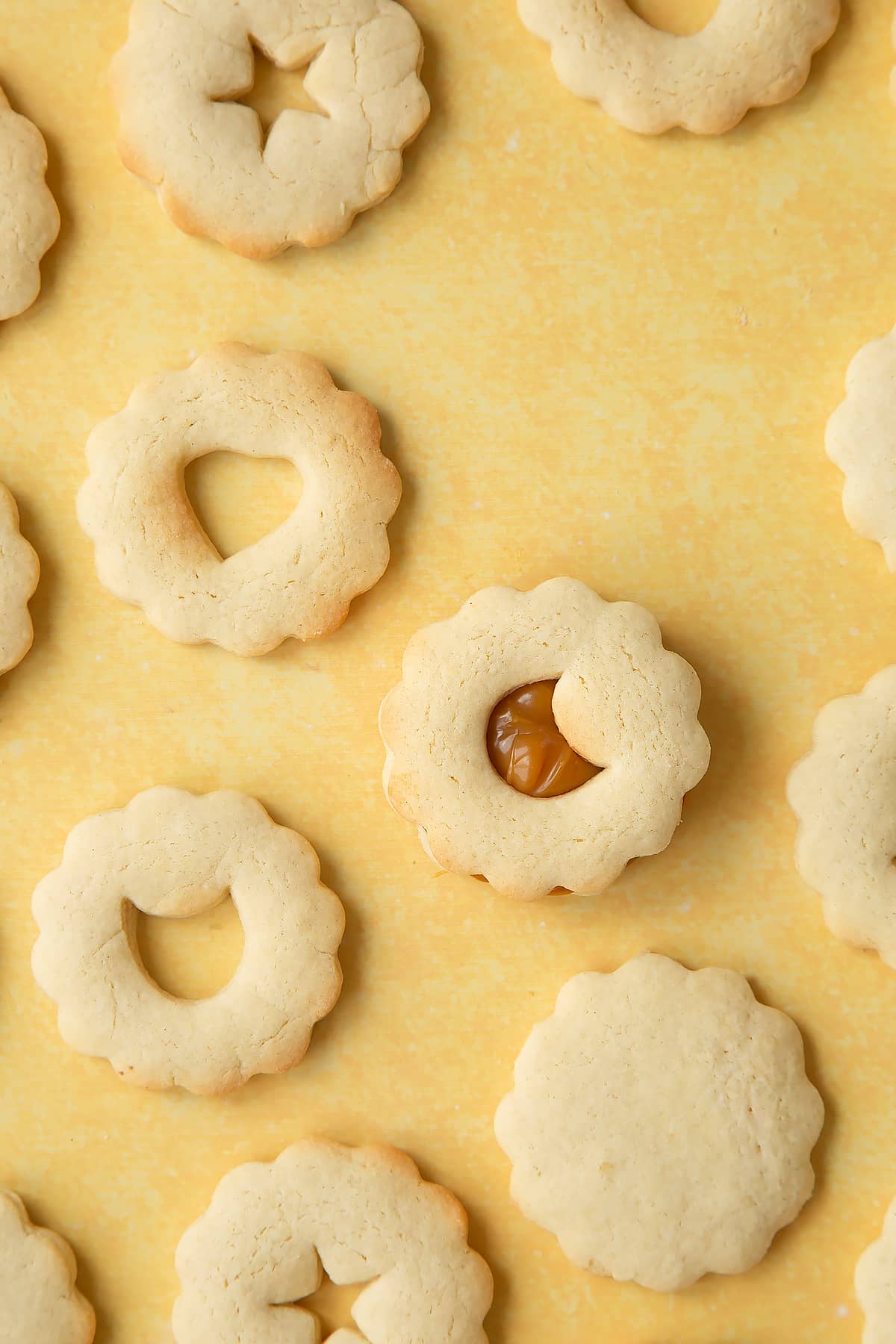 Overhead shot of adding the top to the biscuits 