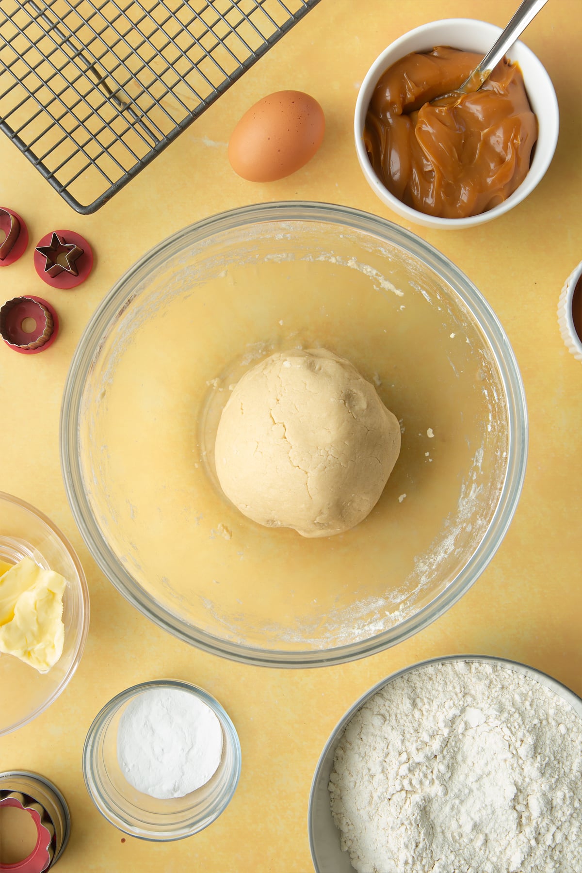 Overhead shot of a ball of dough in a large clear bowl