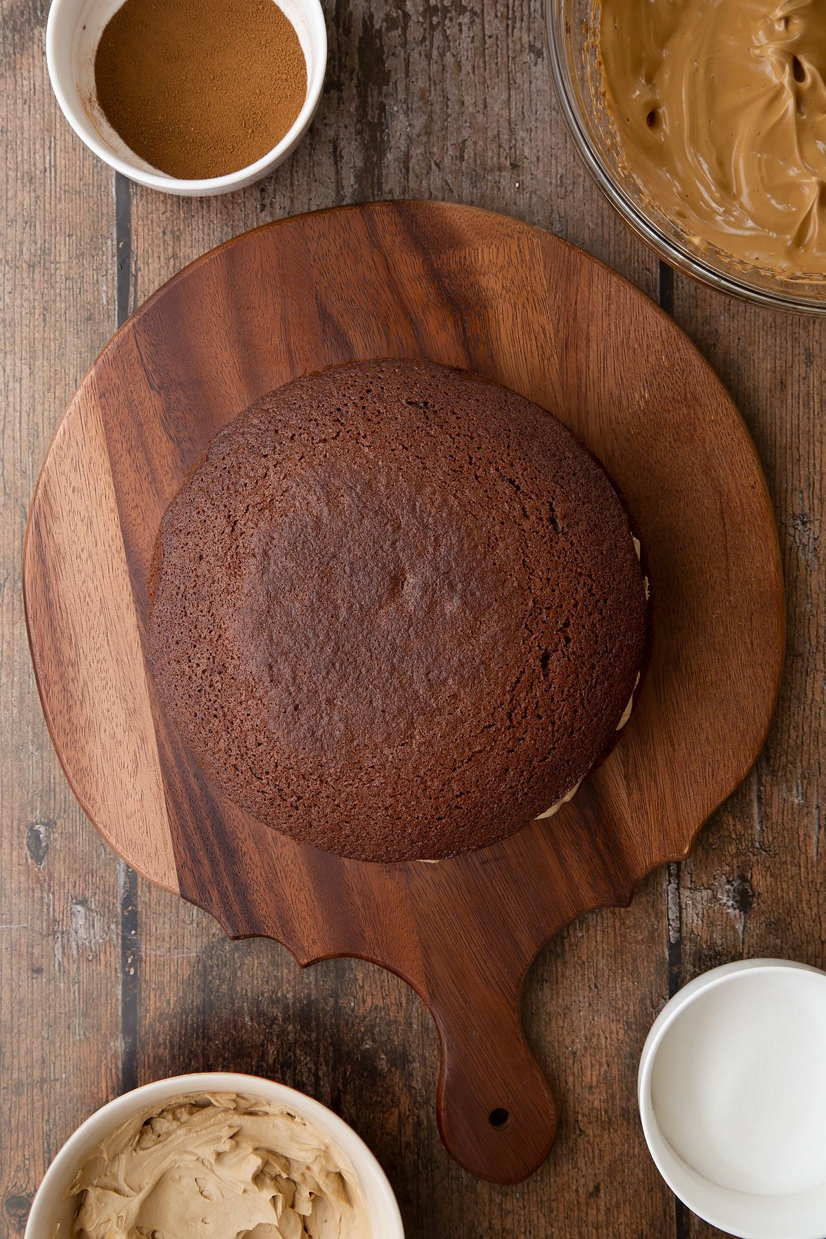 Dalgona coffee cake sponge sandwich on a wooden board. 