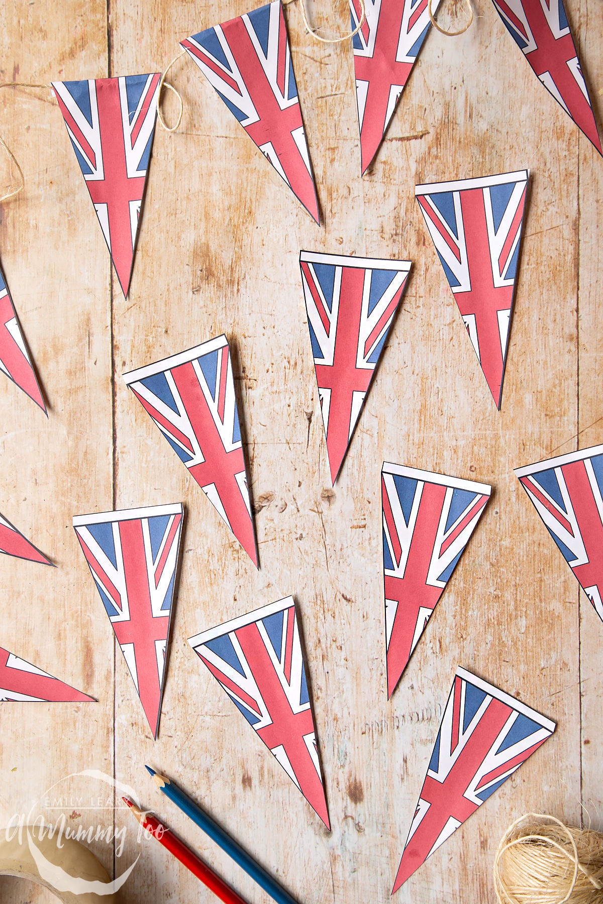 printed coloured sheet of union jack bunting being coloured in cut out and shown as individual pieces.