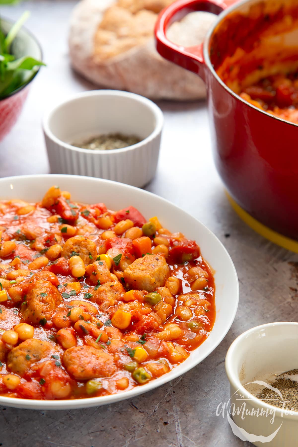 Veggie sausage and bean casserole served into a shallow white bowl. 