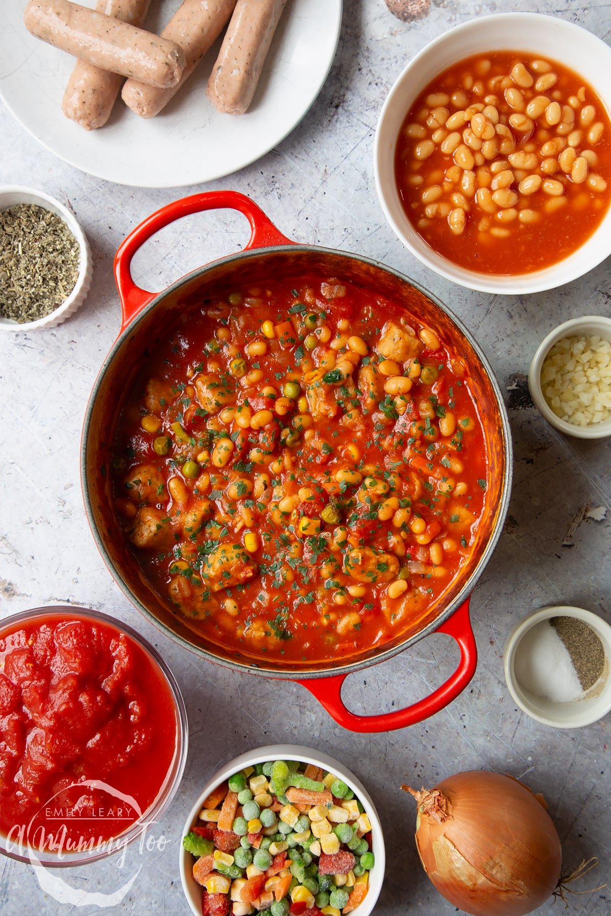 Veggie sausage and bean casserole in a large red pot.