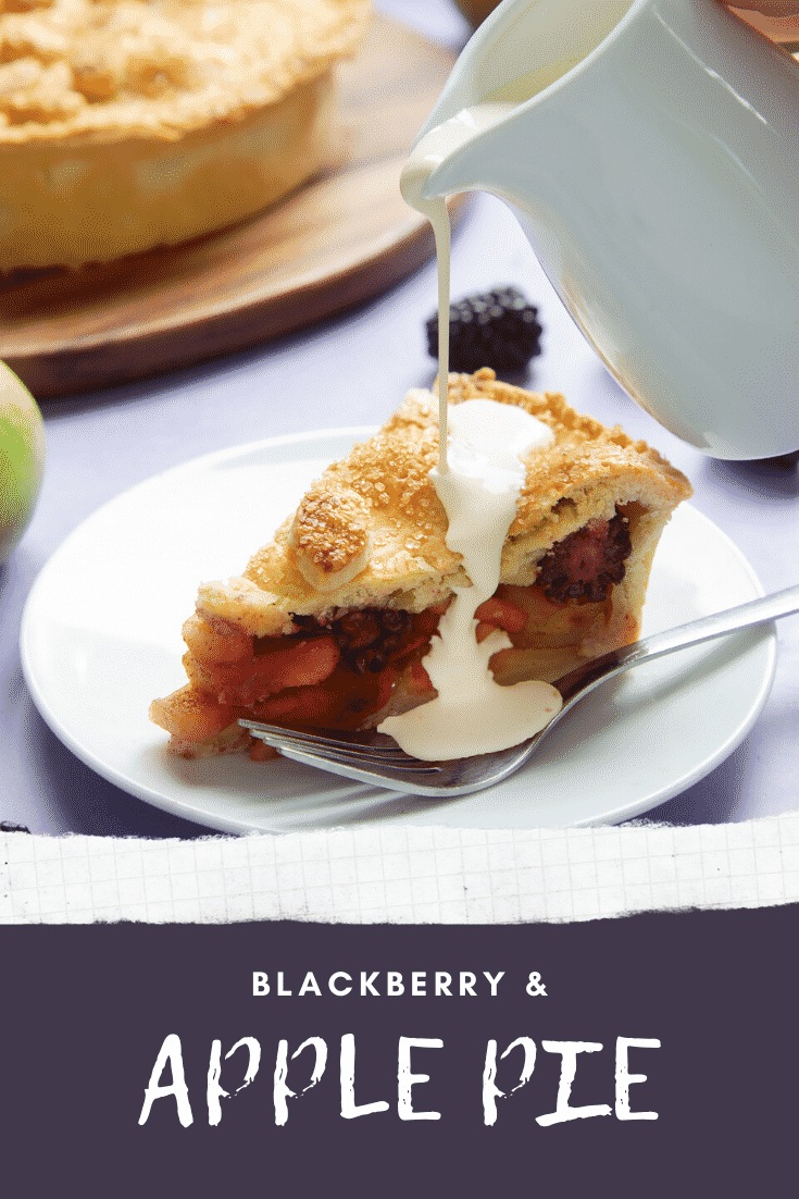 A slice of apple and blackberry pie on a white plate with a fork. Cream has been poured on top. Caption reads: blackberry & apple pie