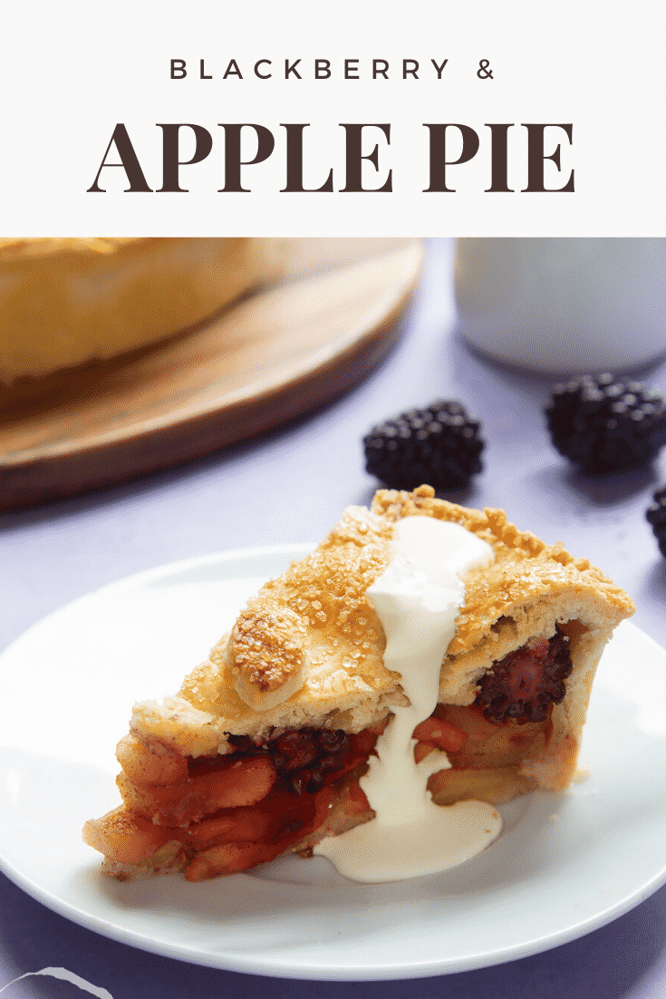 A slice of apple and blackberry pie on a white plate. Cream has been poured on top. Caption reads: blackberry & apple pie