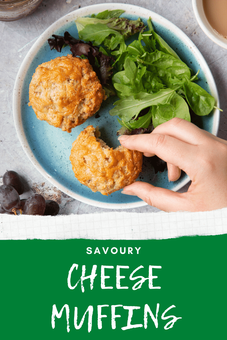 Easy cheese muffins on a plate with salad. A hand reaches to take one with a bite out it. Caption reads: savoury cheese muffins