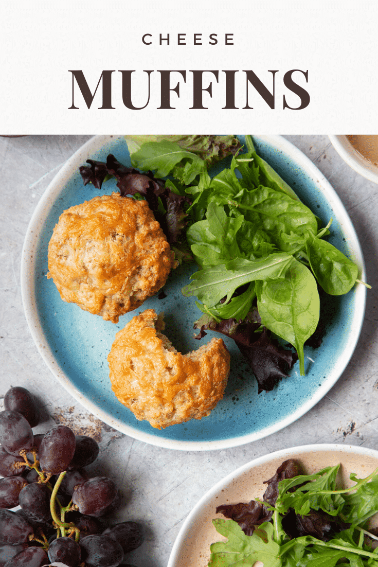 Easy cheese muffins on a plate with salad. There is a bite out of one. Caption reads: cheese muffins